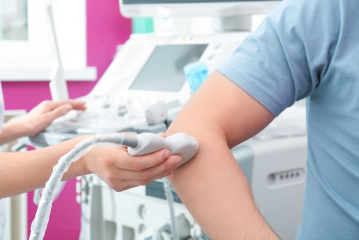 Doctor conducting ultrasound examination of elbow joint in clinic, closeup Ultrasound Guided Injections High Wycombe
